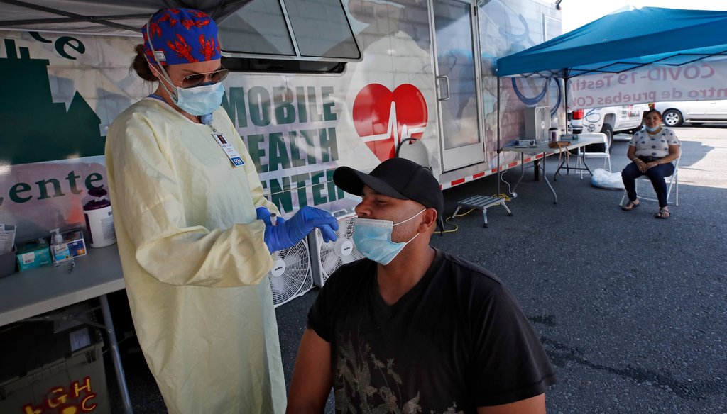 Nurse Tanya Markos administers a coronavirus test on patient Juan Ozoria at a mobile COVID-19 testing unit on July 2, 2020, in Lawrence, Mass. (AP)