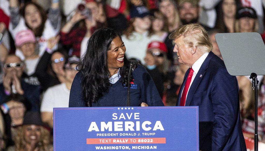 Kristina Karamo, Republican candidate for Michigan secretary of state, shakes hands with former President Donald Trump during a Save America rally at the Michigan Stars Sports Center in Washington Township on April 2, 2022.