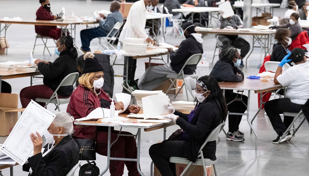 A worker scans ballots as the presidential recount process gets under way Nov. 24, 2020, in DeKalb County, Ga. (AP)