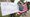 Joseph Offutt, left, and Raheem Peters hold a sign and U.S. flag near the site of the Garland, Texas, shooting of a cartoon contest event of the Muslim prophet Muhammad. (AP)