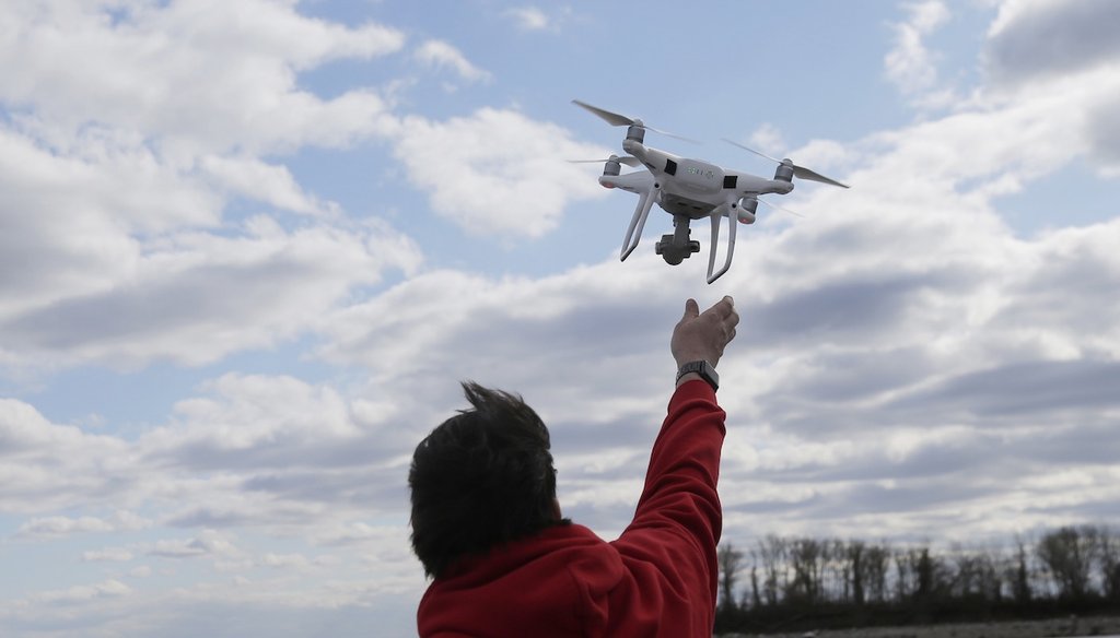 A drone operator helps to retrieve a drone April 29, 2018, after photographing over Hart Island in New York. (AP)