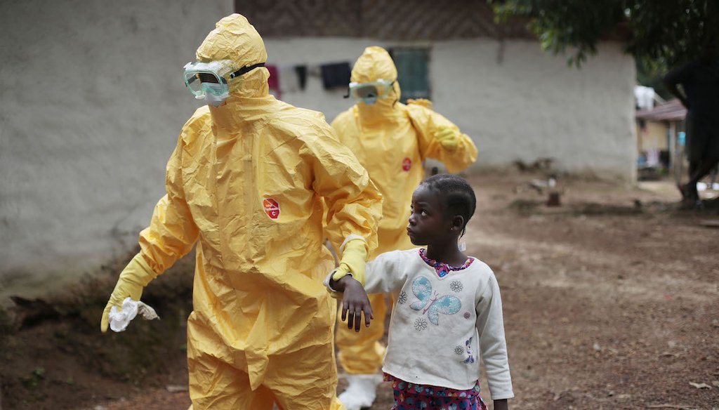 A young girl in Liberia is taken to an ambulance after showing signs of an Ebola infection in this Sept. 30, 2014, file photo. An Ebola outbreak in Western Africa from 2014 to 2016 killed more than 11,000 people. (AP)