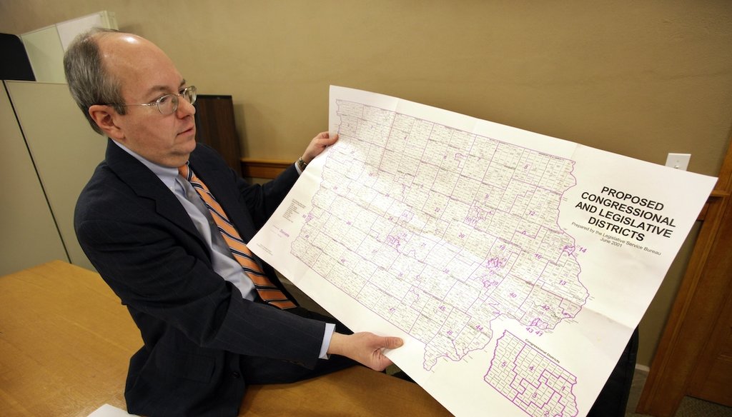 Iowa Legislative Services Agency Legal Counsel Ed Cook shows am Iowa map that will be used to help draw new congressional district lines Feb. 9, 2011, in Des Moines, Iowa. (AP)