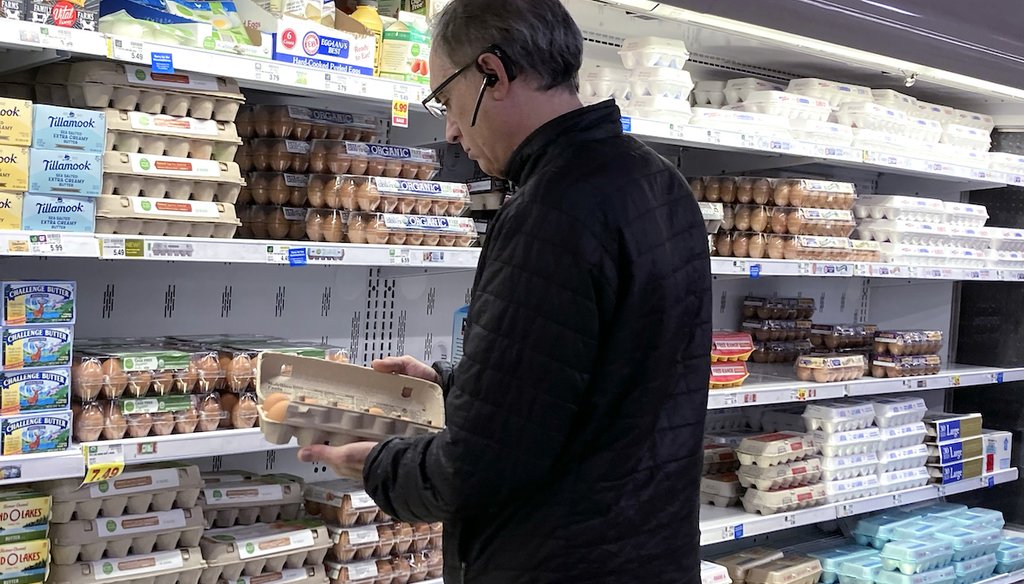 A shopper checks eggs before he purchases at a grocery store in Glenview, Ill., Jan. 10, 2023. (AP Photo/Nam Y. Huh)