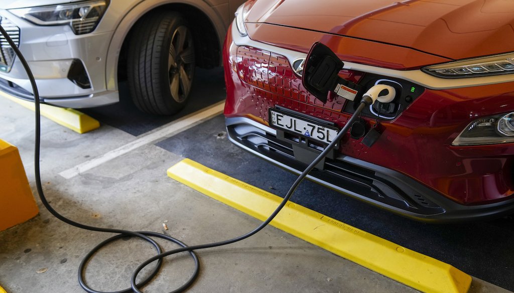 An electric car gets charged at a supermarket parking lot in Sydney, Australia. (AP)