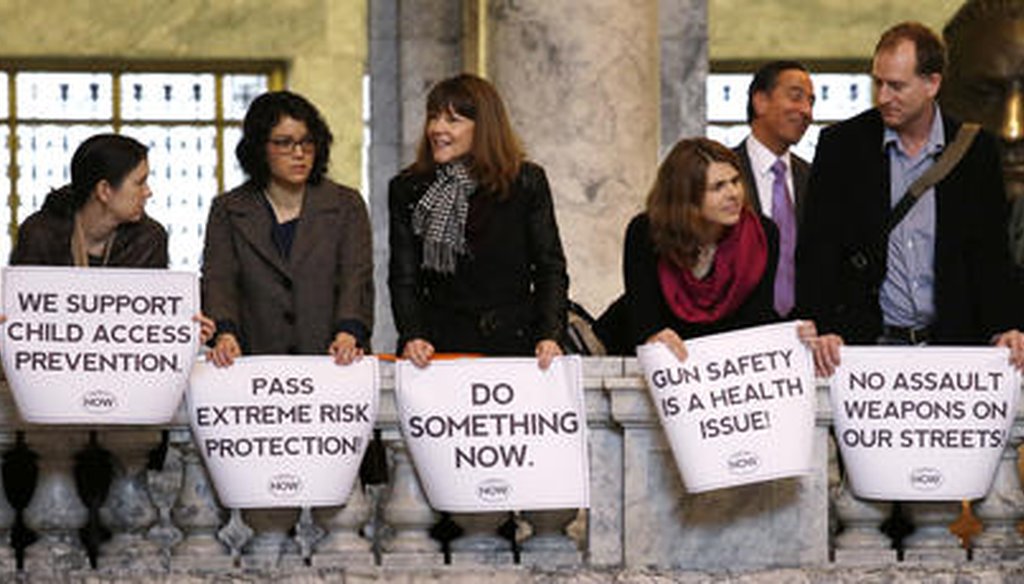 In this file photo taken Jan. 12, 2016, gun regulation activists stand with signs in the Washington state Capitol rotunda. State voters passed an initiative to create extreme risk protection orders. (AP)
