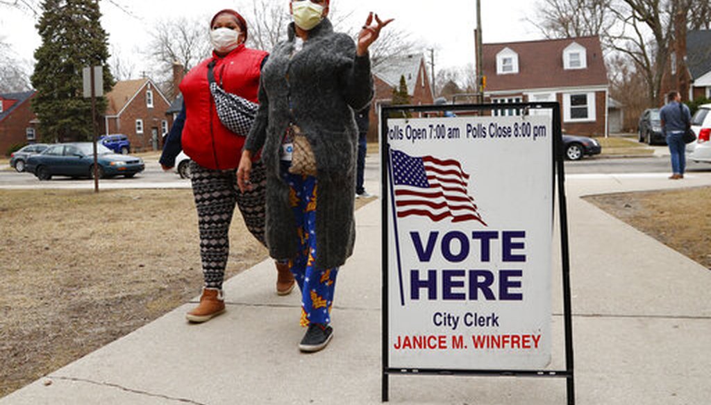 Voters arrive with masks in light of the coronavirus COVID-19 health concern at Warren E. Bow Elementary School in Detroit, Tuesday, March 10, 2020. (AP)