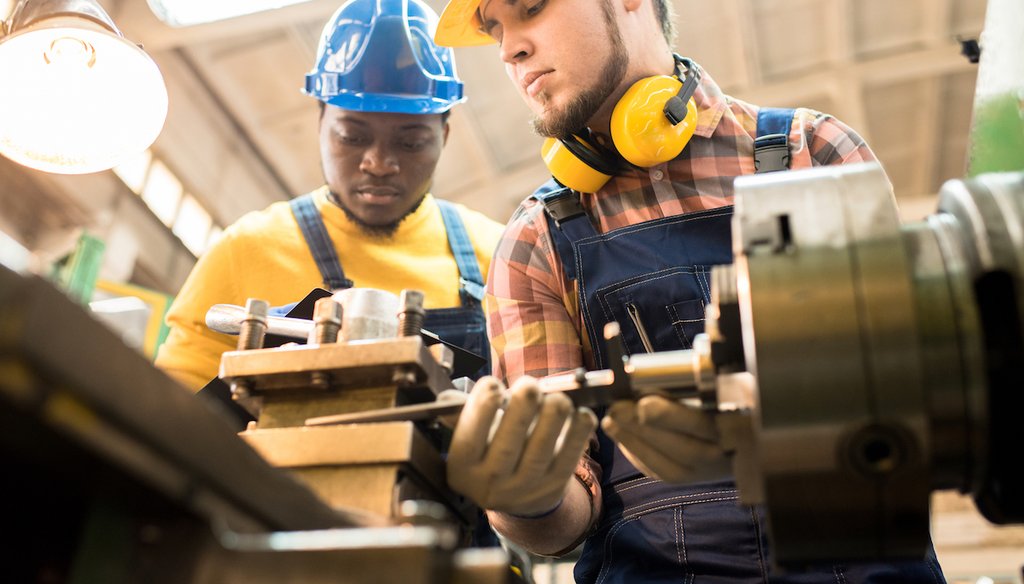 Lathe operators at an American factory. (Shutterstock)