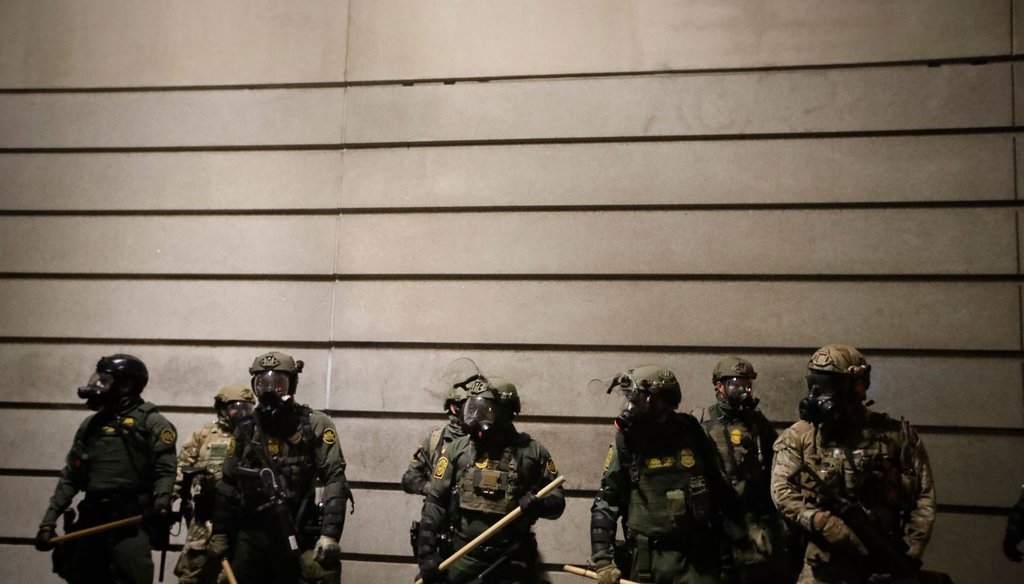 Federal agents watch demonstrators after an illegal assembly was declared during a Black Lives Matter protest at the Mark O. Hatfield United States Courthouse on July 29, 2020, in Portland, Ore. (AP)
