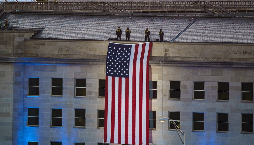 An American flag is unfurled at the Pentagon in Washington, Saturday, Sept. 11, 2021, at sunrise on the morning of the 20th anniversary of the terrorist attacks.  The American flag is draped over the site of impact at the Pentagon. (AP)
