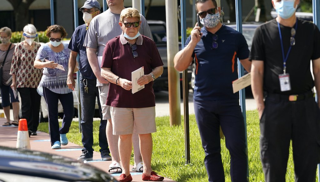 People wait in line to drop off their mail-in-ballots for the general election on Nov. 3, at the Miami-Dade County Elections Department, Wednesday, Oct. 14, 2020, in Doral, Fla. (AP)