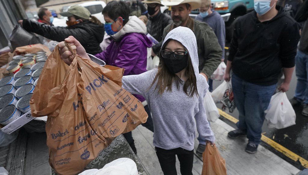 Food donations are brought to a collection site during the Feed Utah food drive Saturday, March 20, 2021, in Sandy, Utah. (AP)