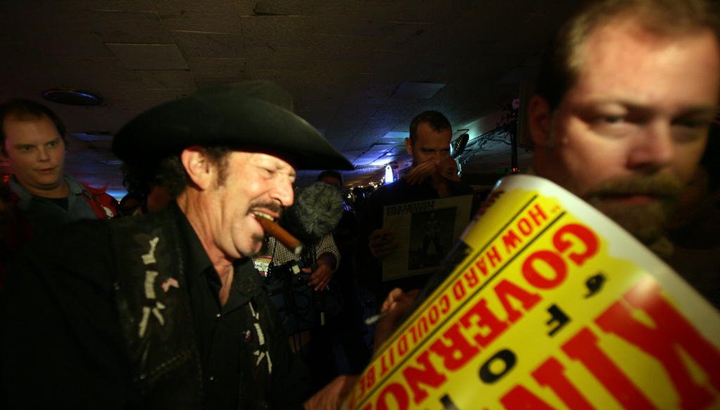 During his 2006 run for governor, singer and humorist Kinky Friedman signs campaign posters at the Broken Spoke dance hall in Austin. (Laura Skelding photo/2006 Austin American-Statesman)
