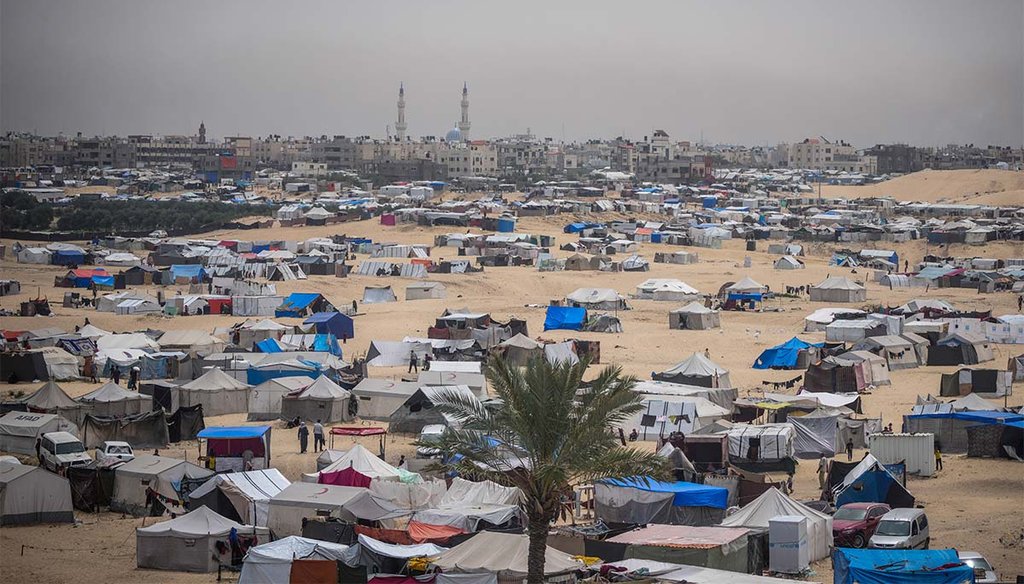 Palestinians displaced by the Israeli air and ground offensive on the Gaza Strip walk through a makeshift tent camp May 10, 2024 , in Rafah, Gaza. (AP)