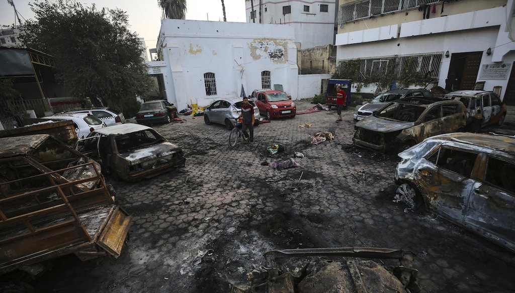 Palestinians check the place of the explosion at al-Ahli hospital, in Gaza City, Oct. 18, 2023. (AP)