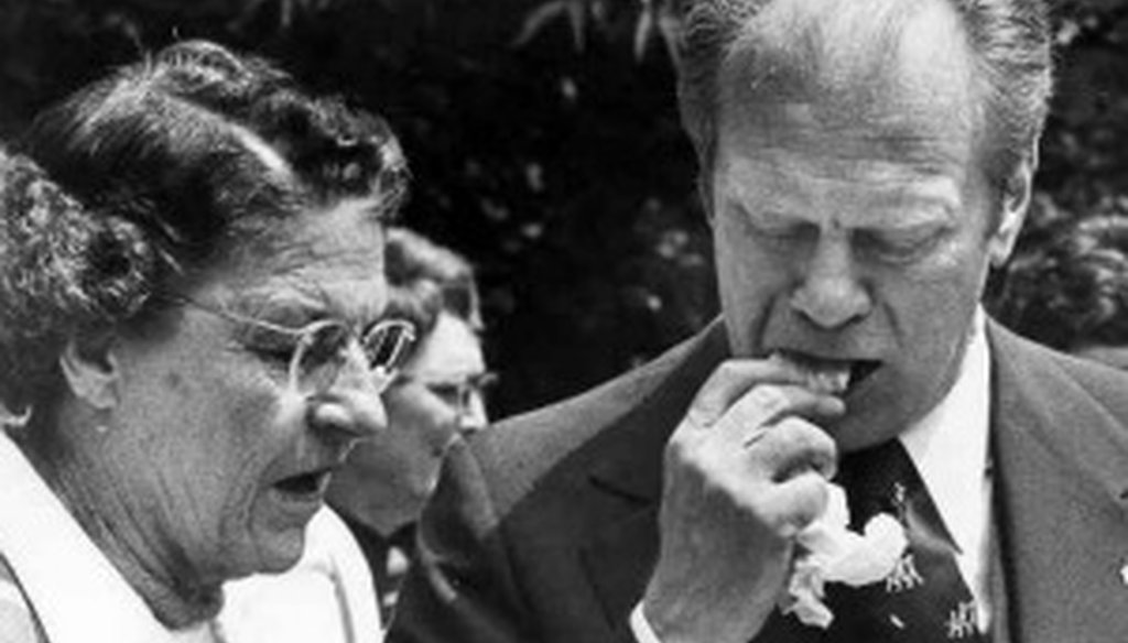 President Gerald Ford bites into a tamale after a tour of the Alamo on April 10, 1976.