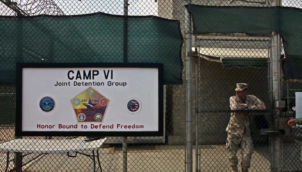 In this May 12, 2009 file photo, a soldier stands guard at the front gate entrance to Guantanamo's Camp 6 maximum-security detention facility, at Guantanamo Bay U.S. Naval Base, Cuba. (AP Photo/Brennan Linsley, File)