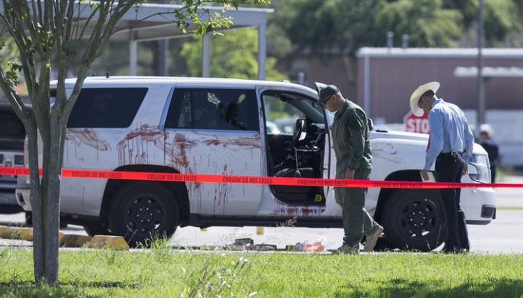 Investigators survey the scene where Harris County Precinct 3 Assistant Chief Deputy Clinton Greenwood was shot in Baytown, Texas, on April 3, 2017. (AP photo)
