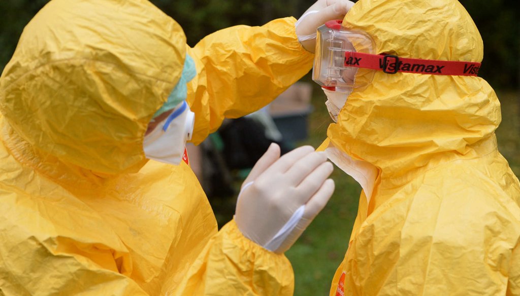 The deadliness of Ebola that has doctors like this one in Germany donning full body protection has spurred conspiracy theories in the United States. (Getty Images)