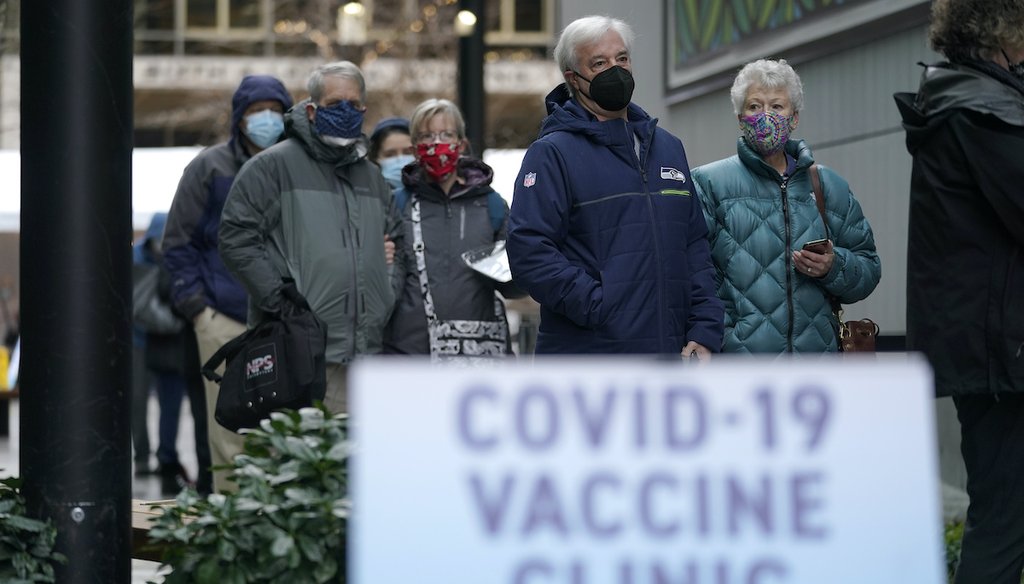 People wait in line to receive the first of two doses of the Pfizer vaccine for COVID-19, Sunday, Jan. 24, 2021, at a one-day vaccination clinic set up in an Amazon.com facility in Seattle and operated by Virginia Mason Franciscan Health. (AP)