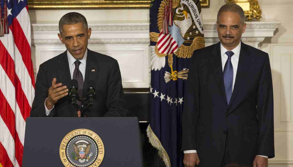 President Barack Obama stands with Attorney General Eric H. Holder Jr. who announced his resignation. (Getty)