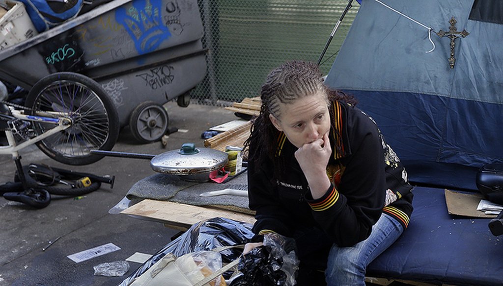 A homeless woman sits with a bag containing her belongings in March 2016 in San Francisco. (AP Photo/Ben Margot)
