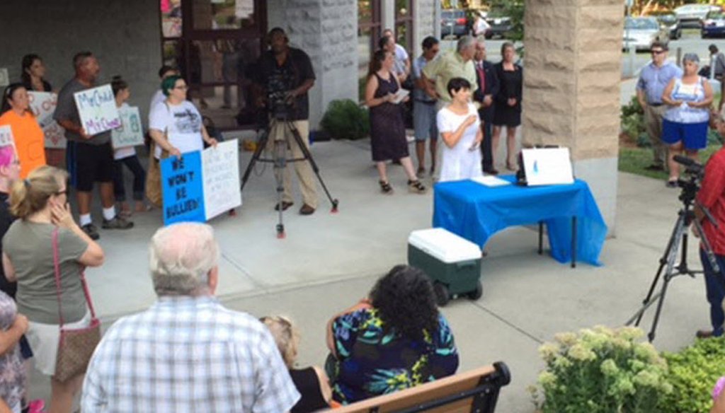 Critics rally against the HPV vaccination policy at the Cumberland Public Library. 