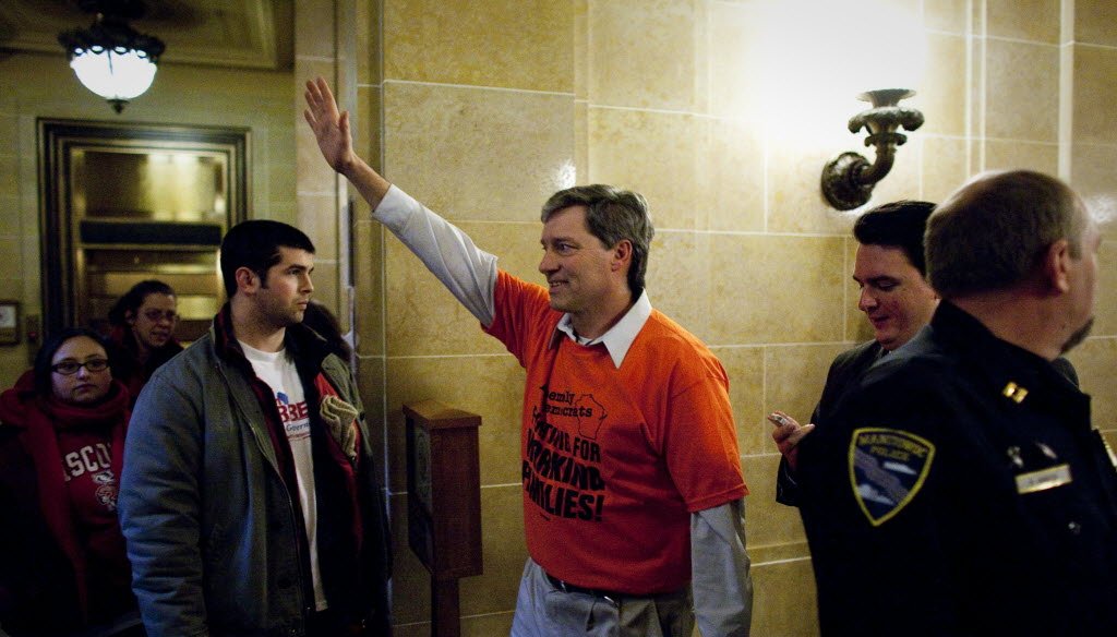 Wisconsin Assembly Democrat Brett Hulsey waves to supporters after he crashed Governor Scott Walker's press conference at the Capitol in Madison on February 23, 2011. JS photo
