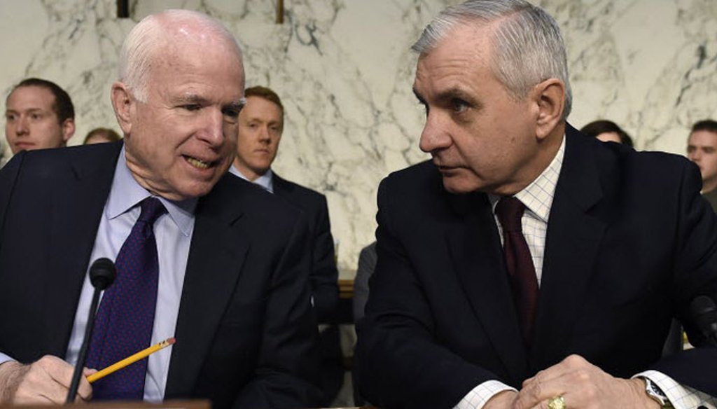 Senators Jack Reed and John McCain confer at a Senate Armed Services Committee in January.