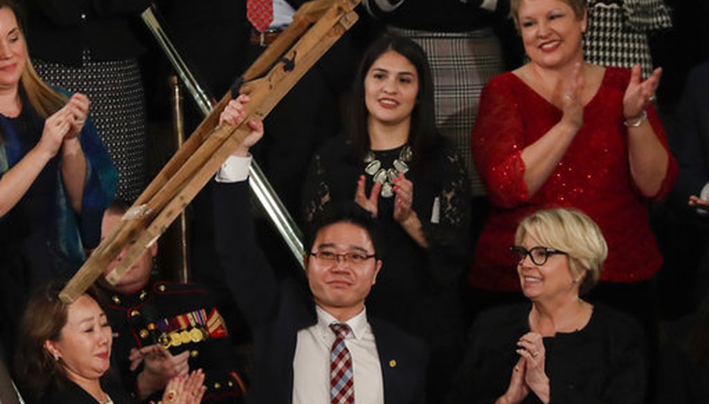 Ji Seong-ho holds up his crutches after his introduction by President Trump during the State of the Union address to a joint session of Congress on Capitol Hill in Washington, Jan. 30, 2018. (AP)