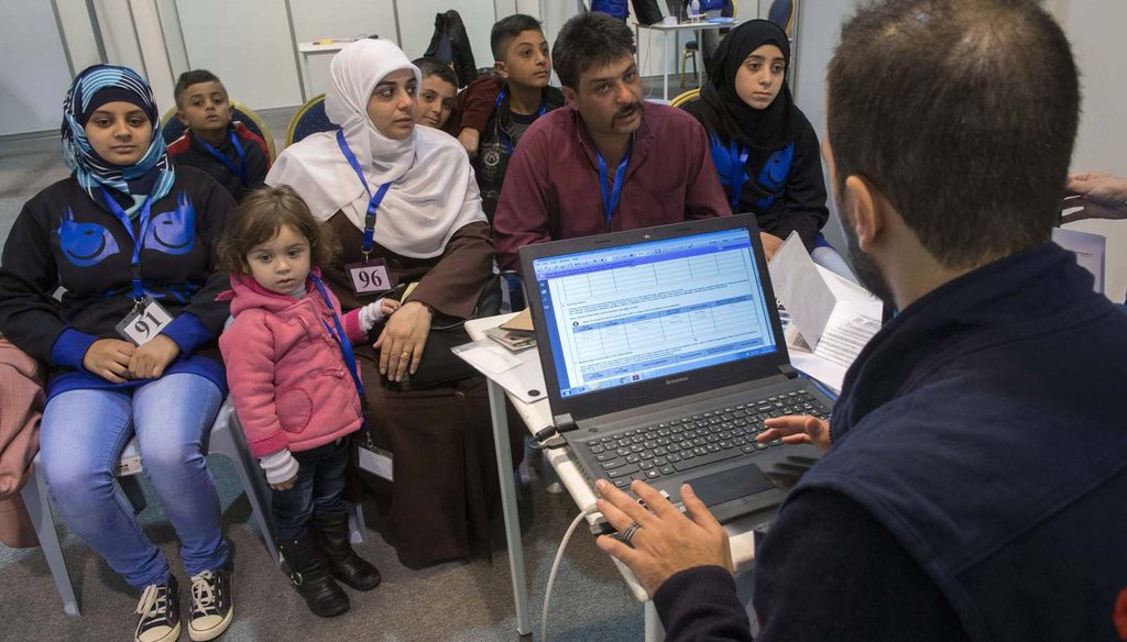 A family of Syrian refugees are interviewed by authorities in hope of being approved for passage to Canada at a refugee processing center in Amman, Jordan, Nov. 29, 2015. (Paul Chiasson/The Canadian Press via AP)