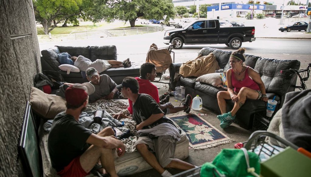 A group of homeless people rest in their camp that has two leather sofas and a mattress under US 183 at Cameron Road in Austin, Texas on July 3, 2019. [JAY JANNER/AMERICAN-STATESMAN]