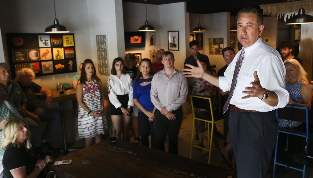 St. Petersburg Mayor Rick Kriseman (right) stands up on a bench as he greets customers and supporters while talking about the stakes in the election during a campaign style stop at Cycle Brewing in St. Petersburg on June 6. (DIRK SHADD | Tampa Bay Times)