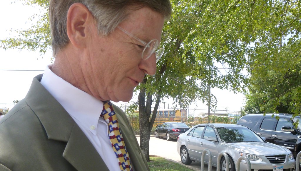 Outside a South Austin restaurant, U.S. Rep. Lamar Smith, R-San Antonio, shows the tax chart he keeps in his wallet with figures he had just used in speaking to the Austin-Oak Hill Rotary Club on Aug. 23, 2012. (Sue Owen photo/Austin American-Statesman)