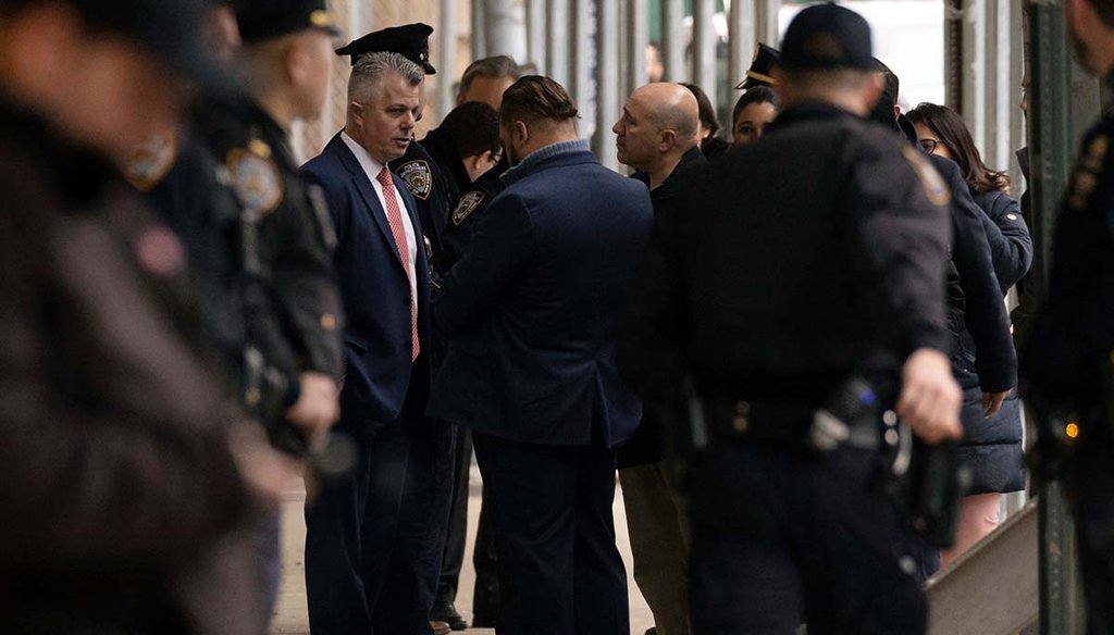 Law enforcement personnel confer March 31, 2023, outside Manhattan Criminal Court in New York. (AP)