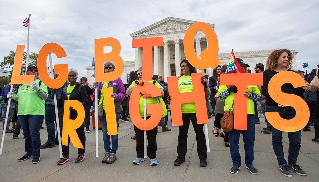 LGBTQ+ rights supporters hold placards Oct. 8, 2019, in front of the U.S. Supreme Court in Washington. (AP)