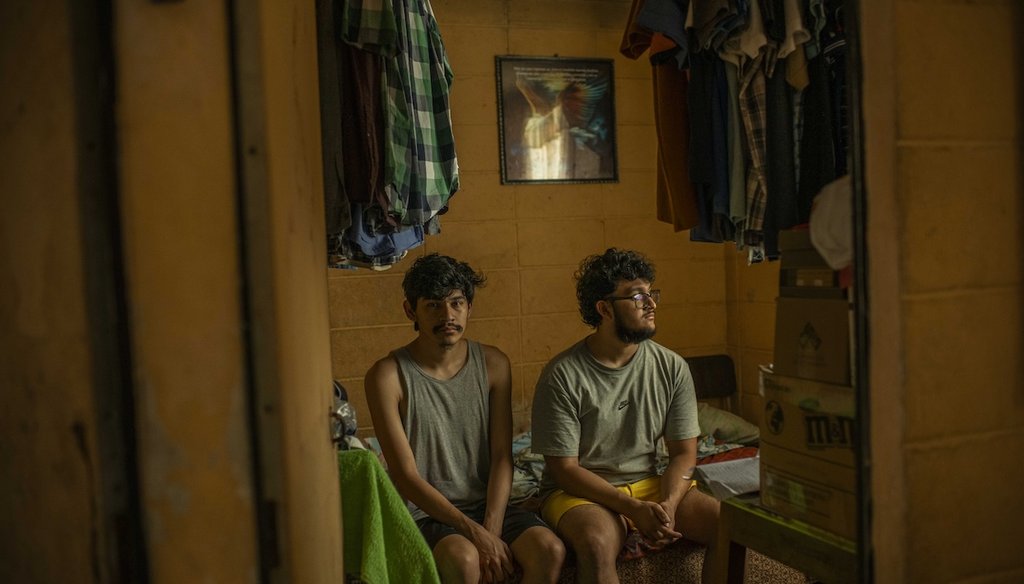 Josué Trejo López, left, and his brother José in a friend’s house in El Salvador. (Photo by Daniele Volpe)