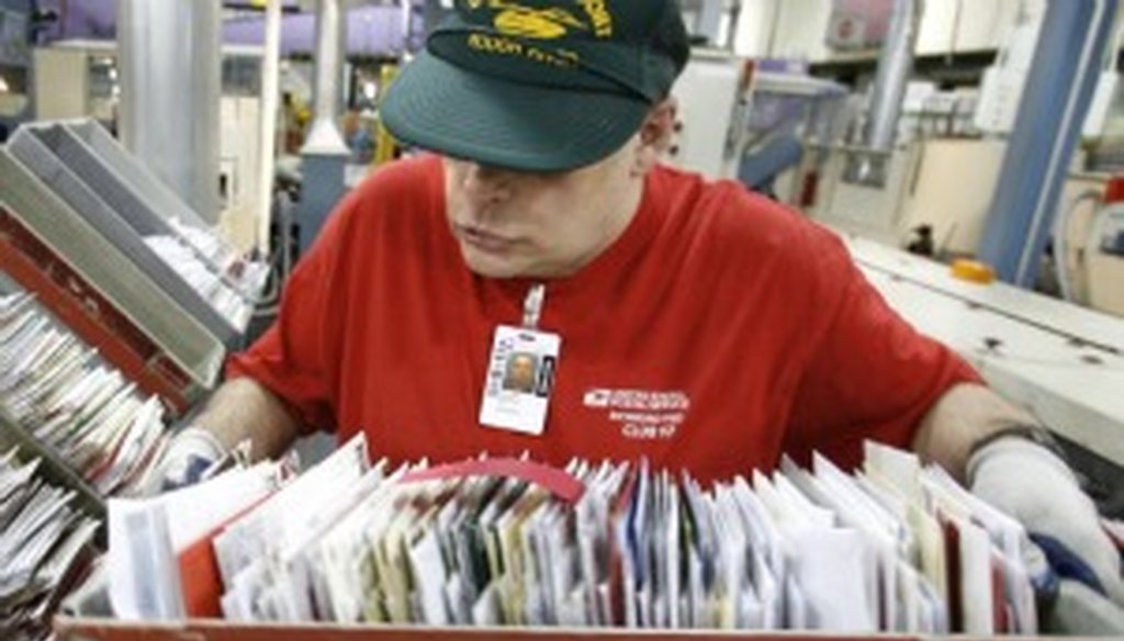Mail piles up, the old-fashioned way (AP photo).