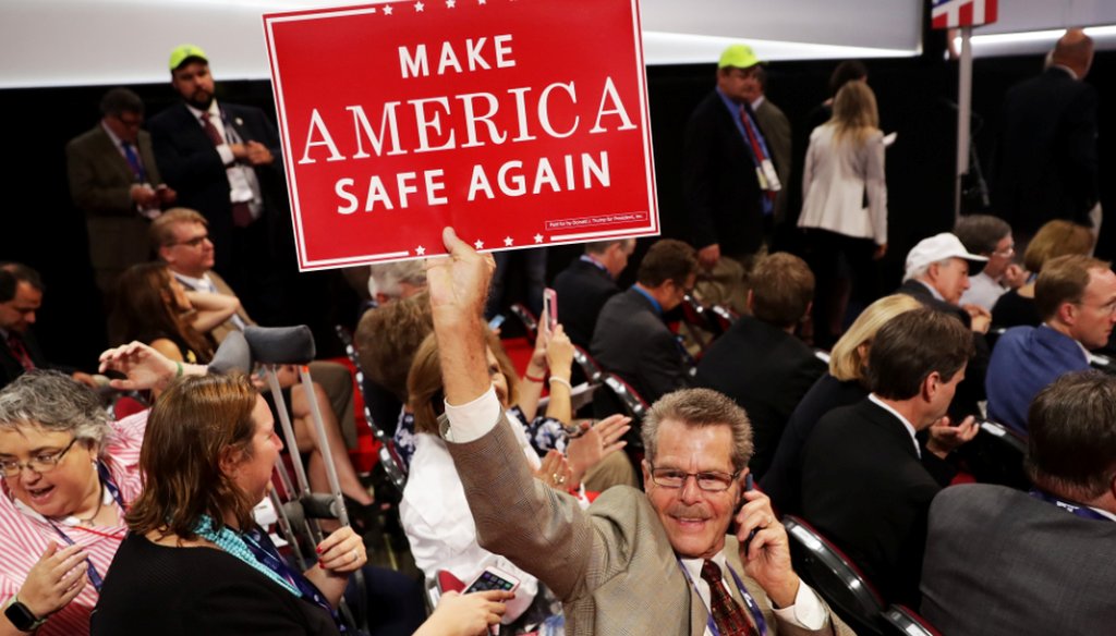 A delegate holds a sign that reads "Make America Safe Again" prior to the start of the evening session on the first day of the Republican National Convention on July 18, 2016 at the Quicken Loans Arena in Cleveland, Ohio. (Getty)