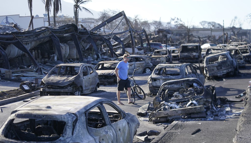A man walks through wildfire wreckage Aug. 11, 2023, in Lahaina, Hawaii. (AP)