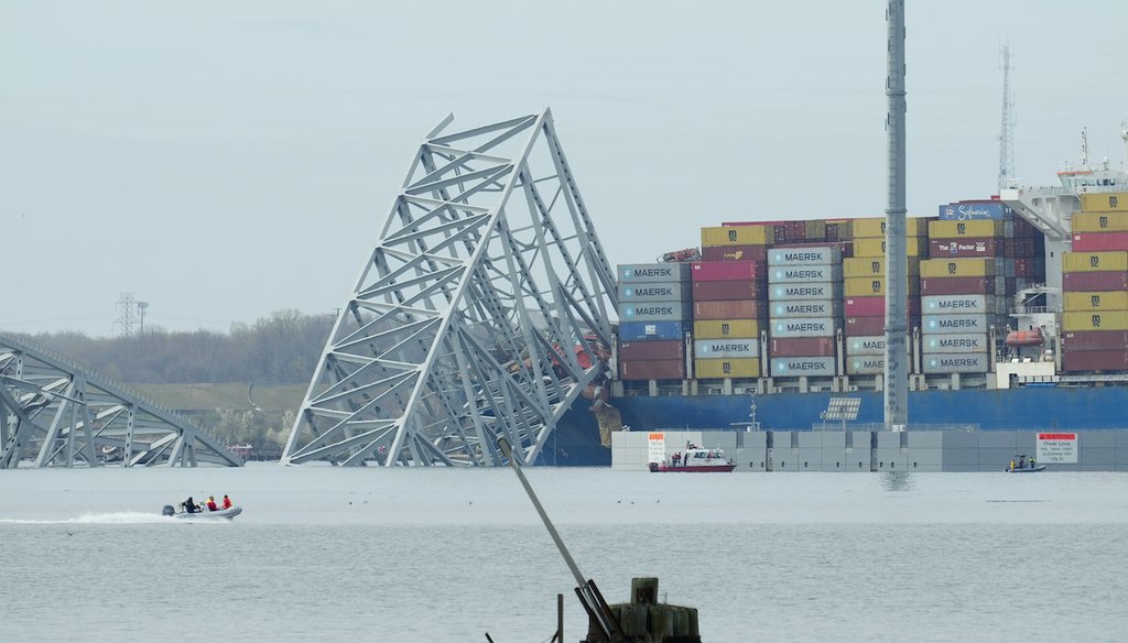 A container ship rests against wreckage of the Francis Scott Key Bridge on March 26, 2024, as seen from Dundalk, Md. The ship rammed into the major bridge in Baltimore, causing it to collapse in a matter of seconds. (AP)