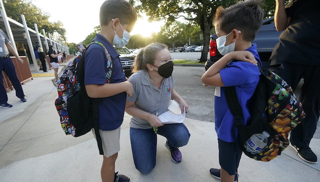 Juliana Orosi checks in students on the first day of class at Fox Trail Elementary School, Friday, Oct. 9, 2020, in Davie, Fla. (AP)