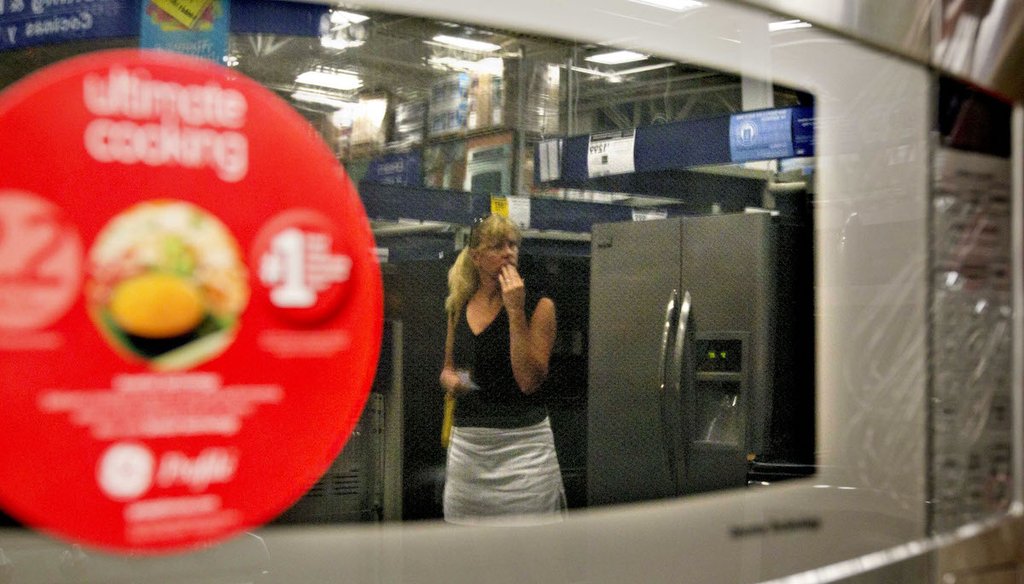 A shopper is reflected in a microwave oven on display at a Lowe's store in Atlanta in 2012. (AP Photo/David Goldman)