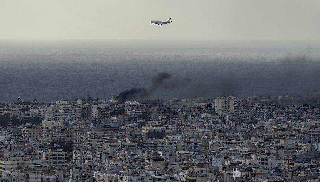 A Middle East Airlines airplane flies over Beirut as smoke rises from Dahiyeh, in Beirut, Lebanon, Oct. 1, 2024. (AP)