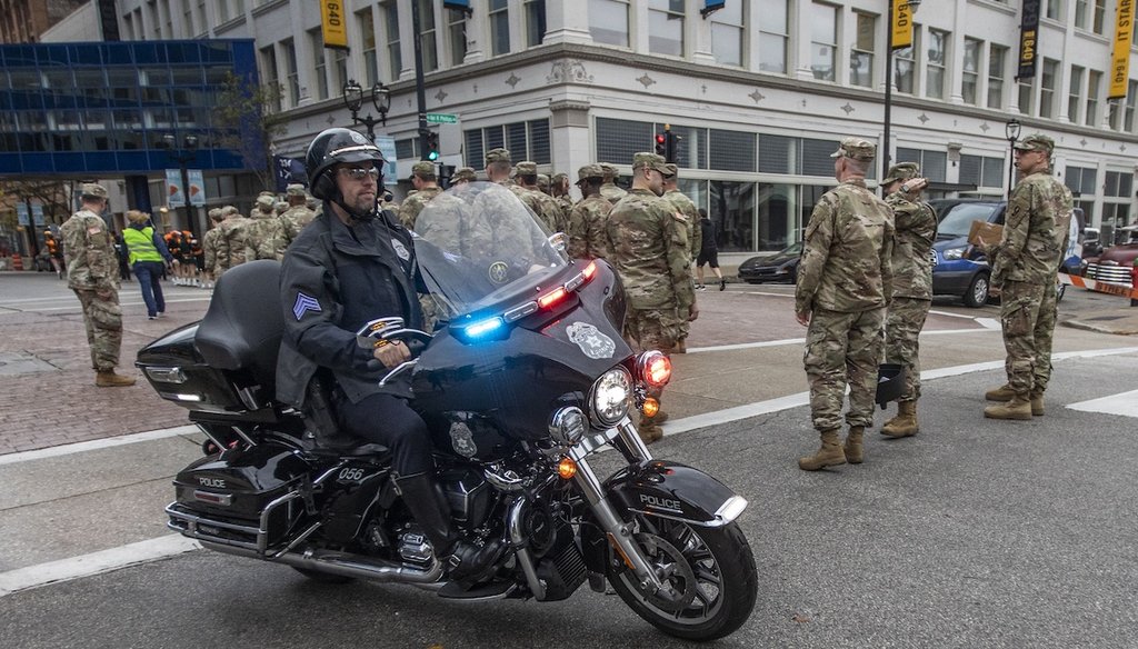 A Milwaukee police officer on a motorcycle drives along the route of a Veterans’ Day parade in Nov. 5, 2022. (AP)