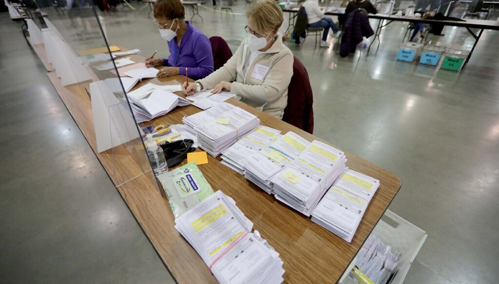 Election workers count absentee ballots during the presidential election recount at the Wisconsin Center Tuesday, Nov. 24, 2020, in Milwaukee (Photo by Mike De Sisti / Milwaukee Journal Sentinel)