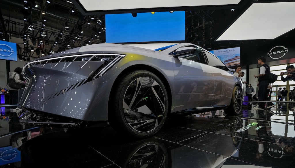 A visitor takes a photo of a Nissan EVO Concept car model on display April 28, 2024, during the Auto China 2024 in Beijing. (AP)