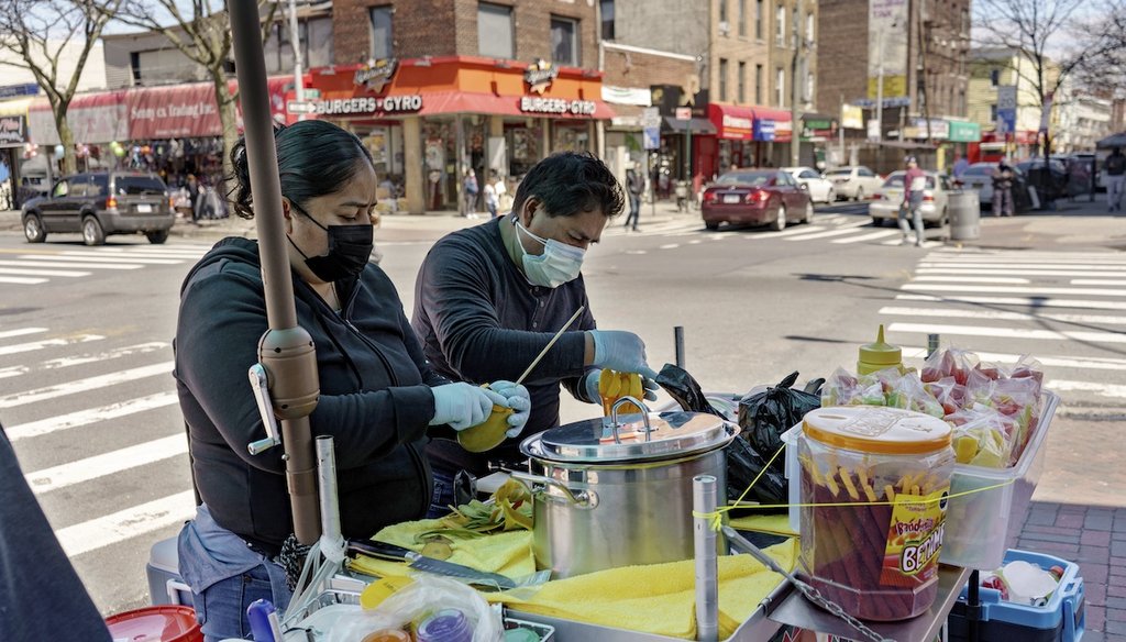 Ruth Palacios and Arturo Xelo, a married couple from Mexico, work April 13, 2021, at their Queens, New York, fruit stand. The couple sued the contractor that had previously hired them, alleging their pay was cut without their knowledge. (AP)