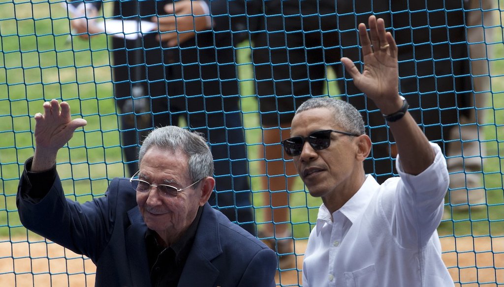 Former President Barack Obama and former Cuban leader Raul Castro wave to fans as they arrive for a baseball game in Havana between the Tampa Bay Rays and Cuban national team on March 22, 2016. (AP)