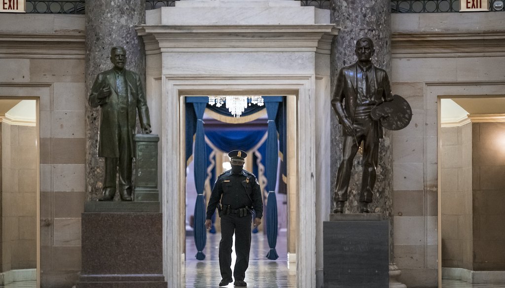 A U.S. Capitol Police officer patrols the area near the House of Representatives chamber after enhanced security protocols were enacted, including metal detectors for lawmakers, Jan. 12, 2021. (AP)